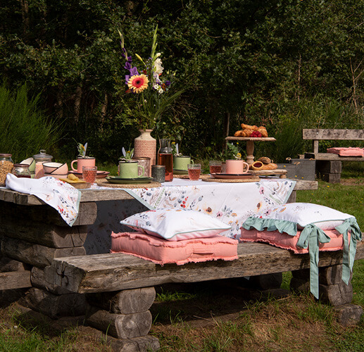 Decorated picnic table with cushions.
