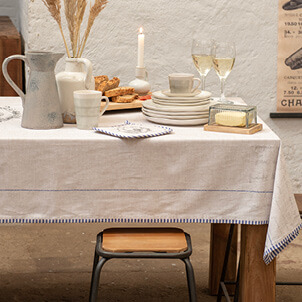 Beautifully set table with a white tablecloth.