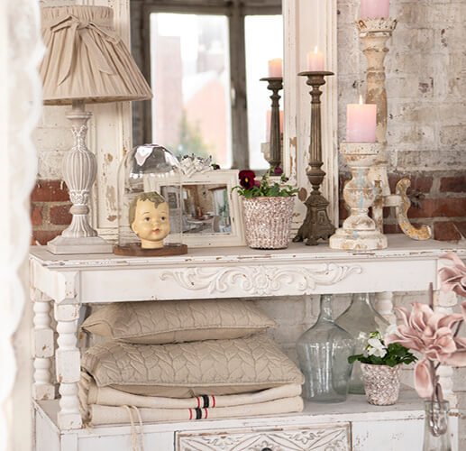 A wall cabinet with a mirror and cushions.