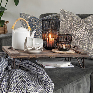 A tray with a tea set and candles