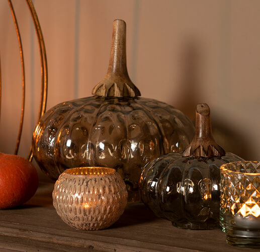 Glass pumpkins with a couple of candleholders.