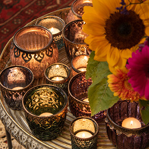 Tealight holders with a couple of flowers.