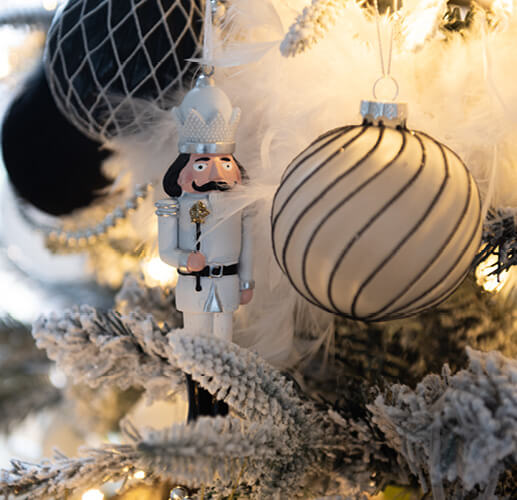 White Nutcracker in a Christmas tree.