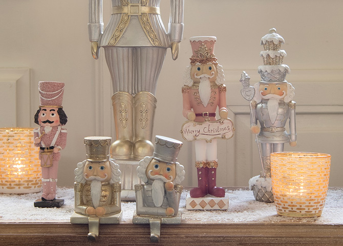 Collection of nutcrackers in various colours and golden tealight holders