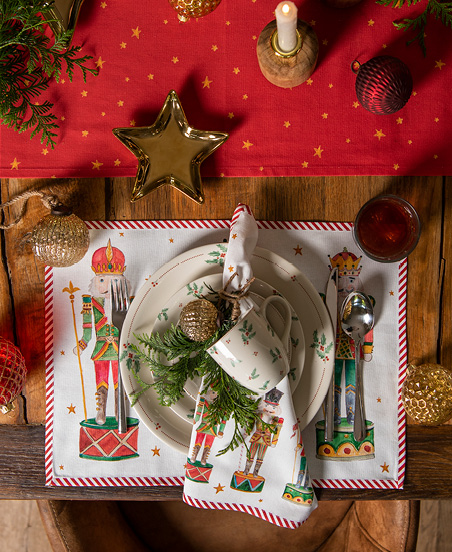 A beautifully set table with Christmas textiles and dinnerware