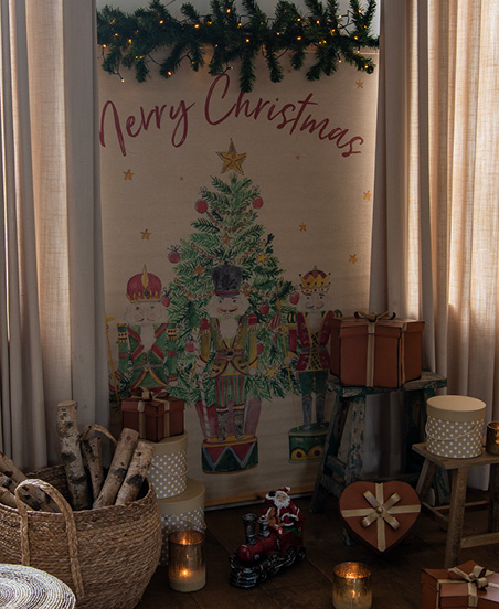 A rustic space with Christmas decorations and a wall tapestry featuring nutcrackers and a Christmas tree