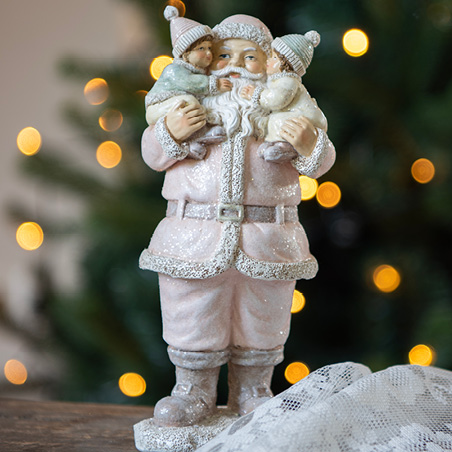 A pink Santa Claus figurine carrying two children