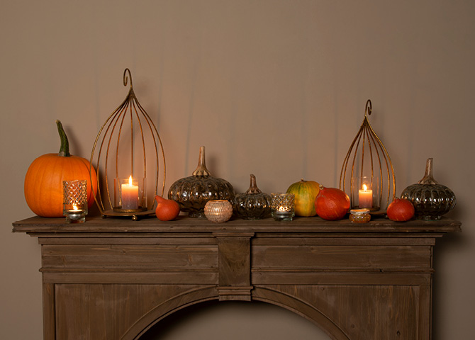 Mantelpiece with candleholders and pumpkins