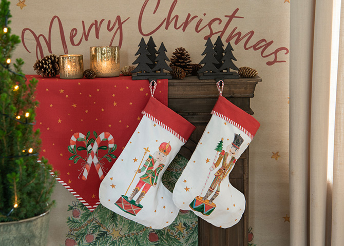 Mantelpiece decorated for Christmas, including a Christmas stocking and table runner