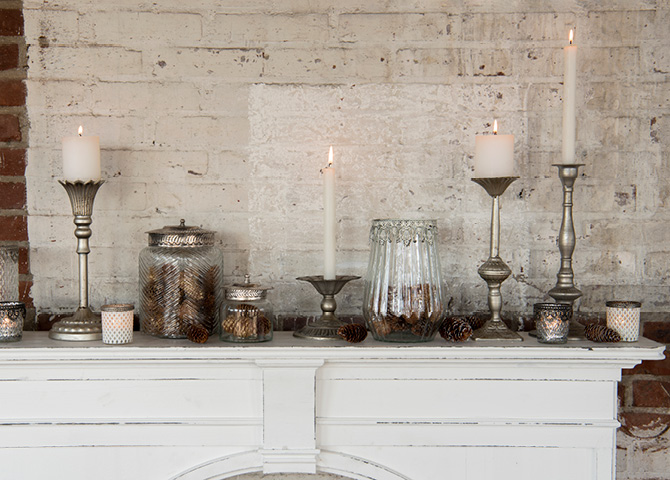 Shabby Chic mantelpiece filled with candleholders and glass jars