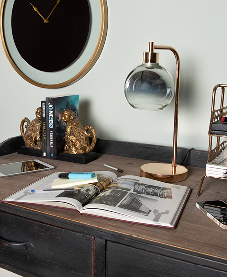 Home office with a book and desk lamp