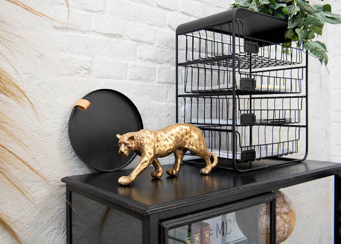 A gold tiger figurine, a tray, a rack, and a globe in an industrial style.