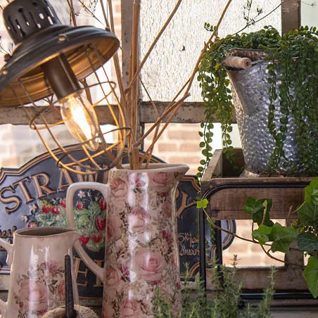 A lamp with pitchers and a flowerpot.