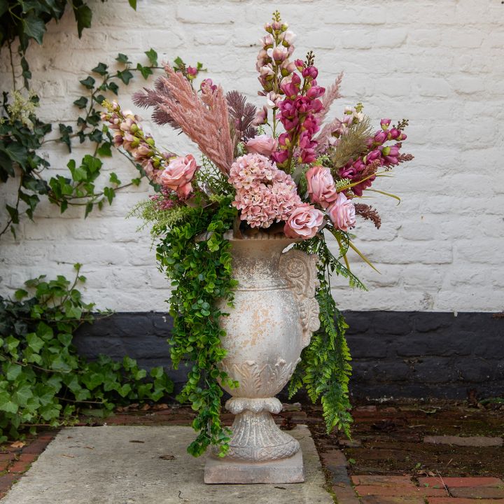 Two small glass vases filled with flowers.