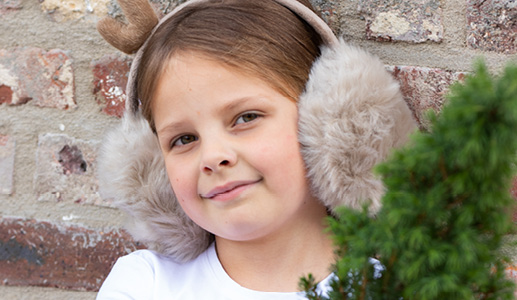 A girl wearing beige earmuffs