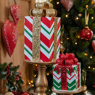 Two decorative gifts in traditional Christmas colors like green, red, and gold