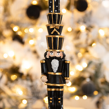 A black nutcracker with gifts