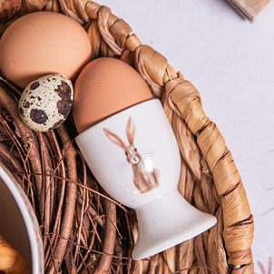 A white egg cup with a rustic bunny on it