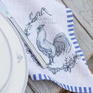 A linen tea towel with a rustic drawn rooster on it