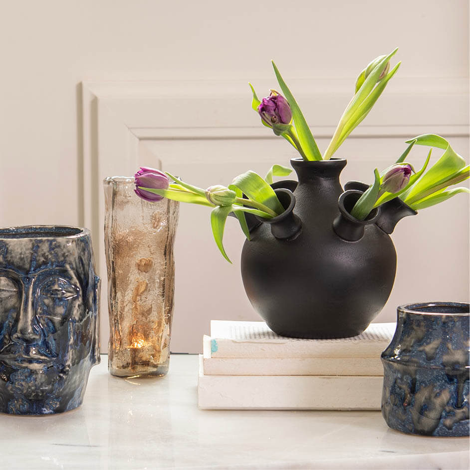 Modern home accessories such as vases and sleek flower pots fit perfectly in a modern interior