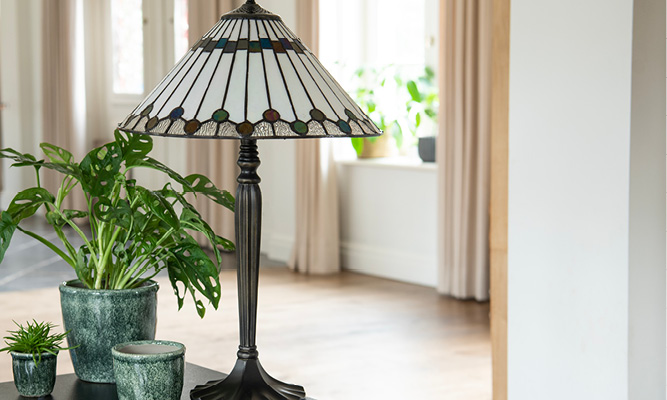 A modern Tiffany table lamp with classic elements in a modern interior style with green flower pots